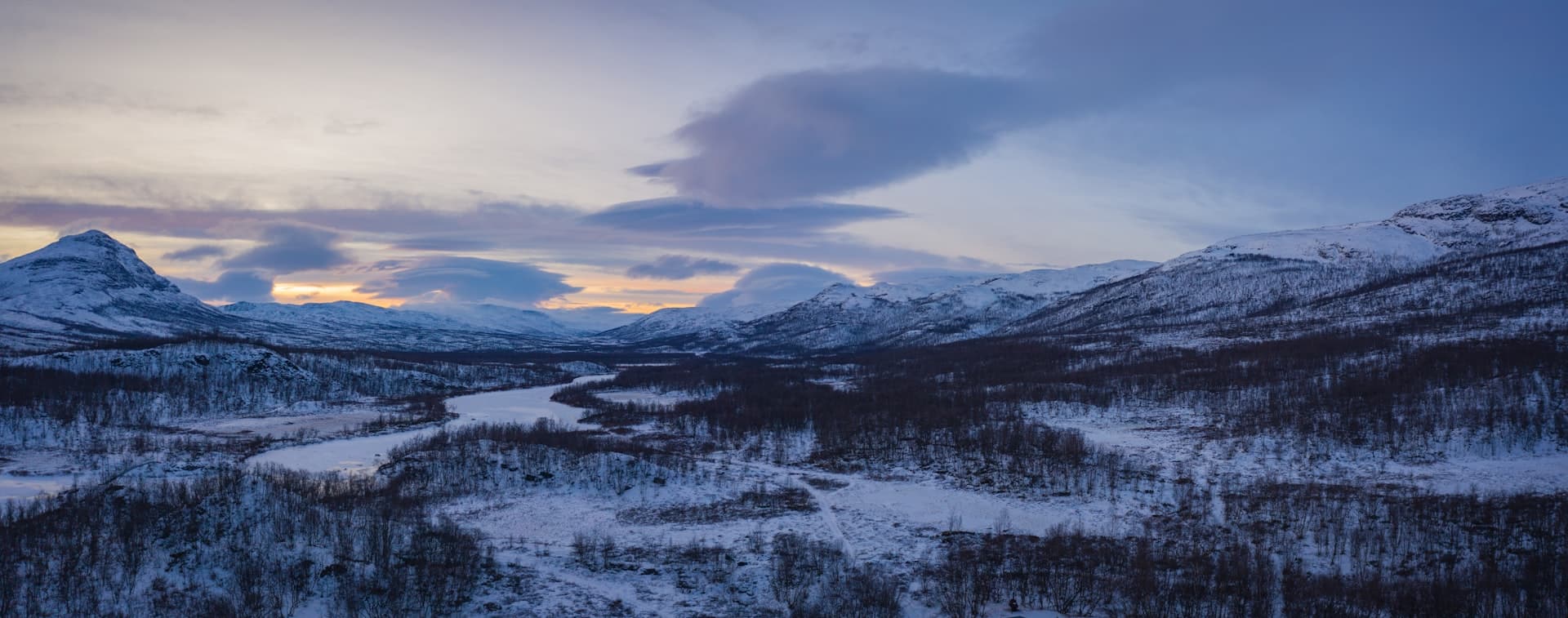 Snow covered mountain under cloudy sky